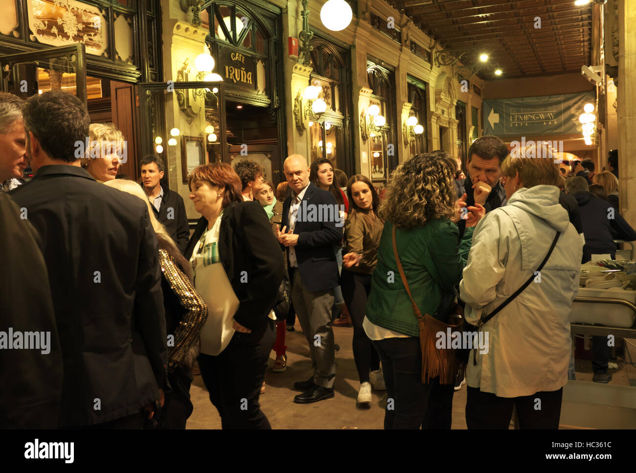 Visitors socialize in the arcade outside Cafe Iruna, the historic cafe in Pamplona, Spain, made famous by Ernest Hemingway in The Sun Also Rises. Stock Photo