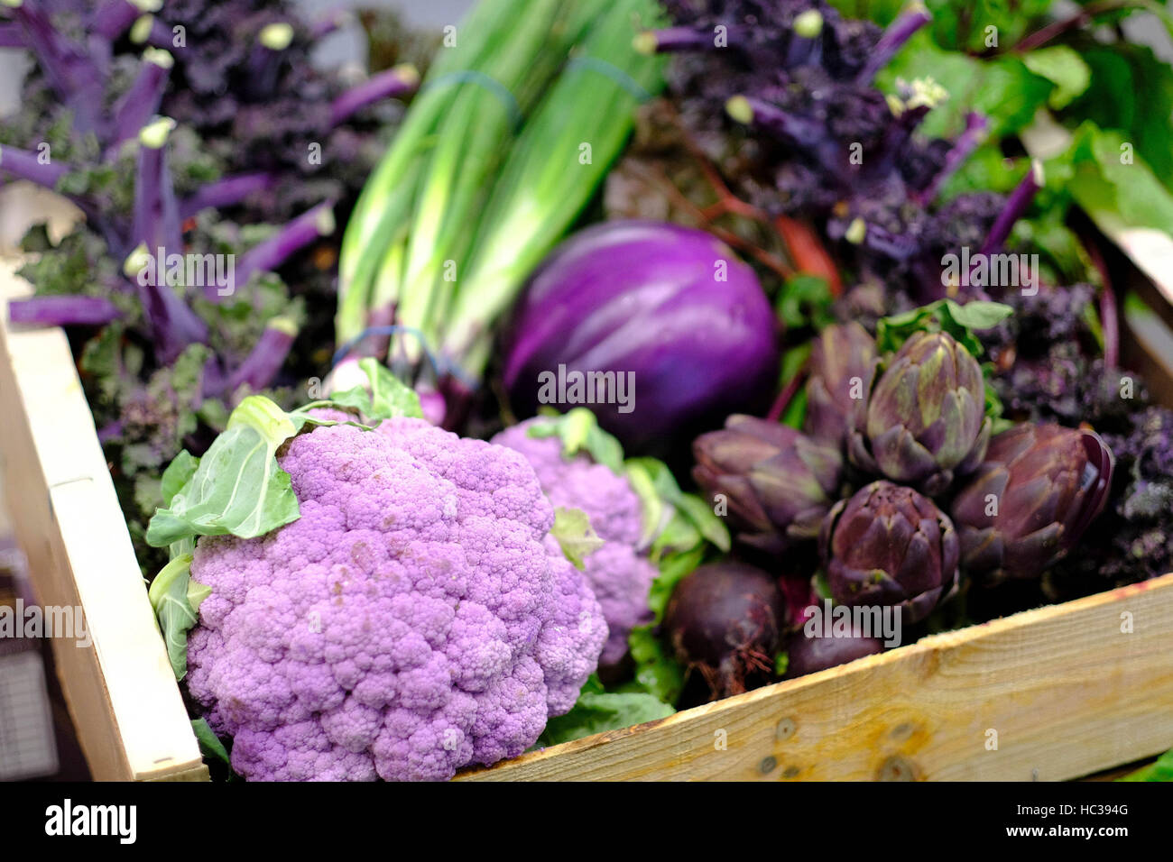 EDITORIAL USE ONLY Traders prepare boxes of purple seasonal vegetables ahead of Christmas at New Covent Garden Market, in Nine Elms, London. Stock Photo