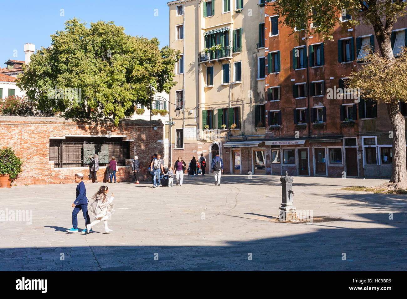 VENICE, ITALY - OCTOBER 12, 2016: people on main square The Venetian Ghetto (Campo del Ghetto Novo). Ity was the area of Venice in which Jews were com Stock Photo