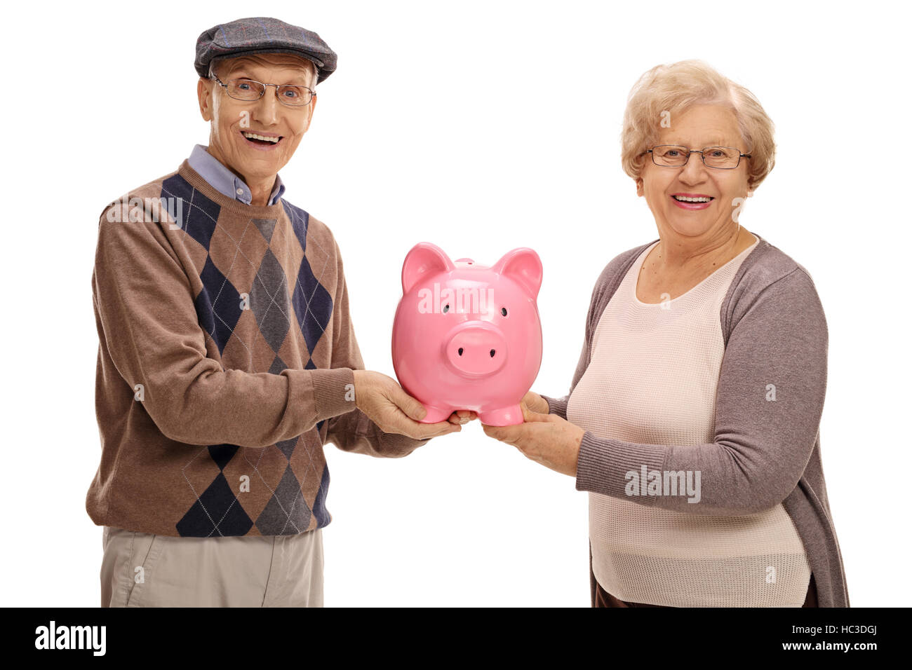 Happy seniors holding a piggybank isolated on white background Stock Photo