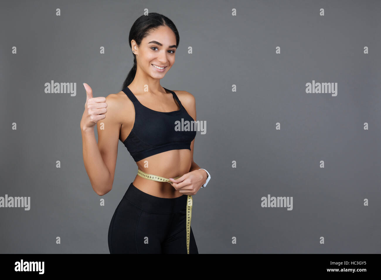 Satisfied kind brunette holding thumb up Stock Photo