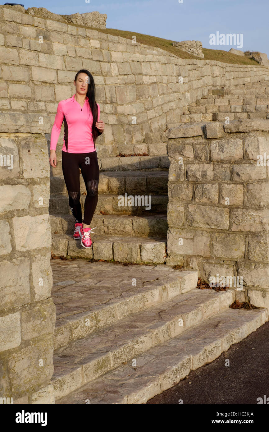 a young female exercising during her daily keep fit routine outdoors england uk Stock Photo