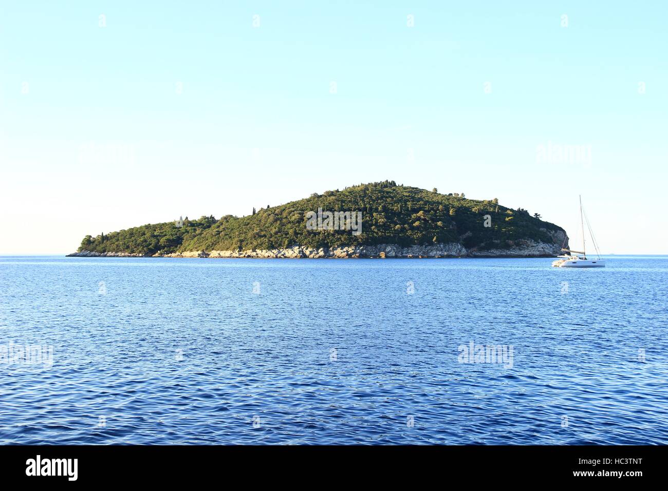Green island in blue sea Stock Photo - Alamy