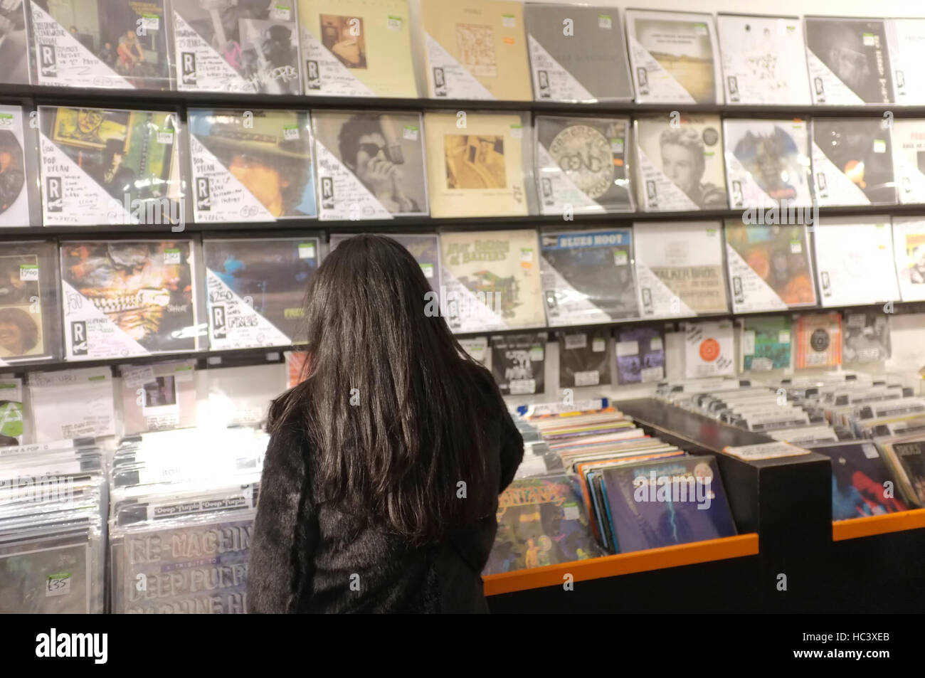 Japanese music fan looking at records in a London second-hand record shop. Stock Photo