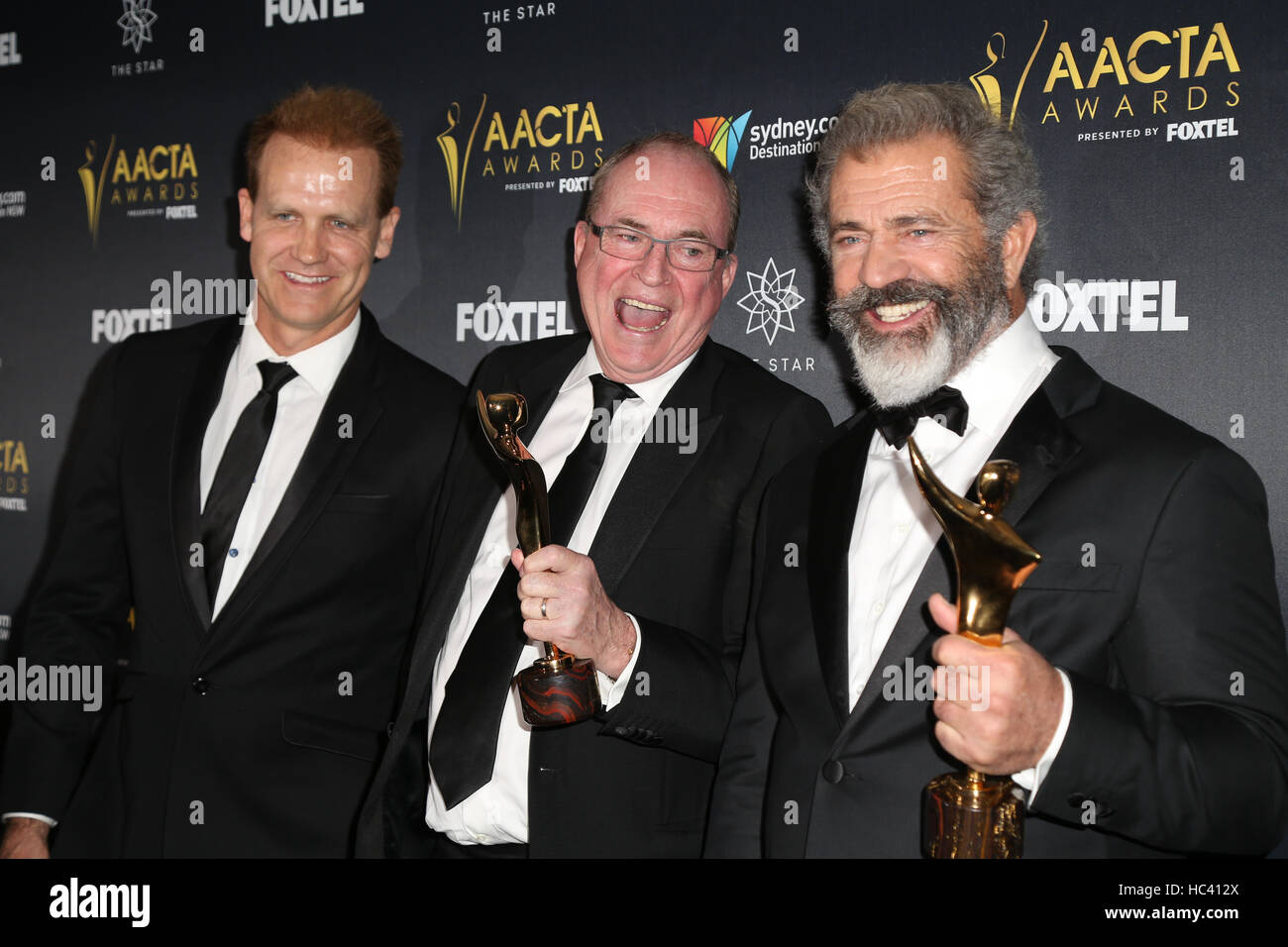 Sydney, Australia. 7 December 2016. Pictured, L-R: Paul Currie, Bruce Davey and Mel Gibson from the movie Hacksaw Ridge speak to the media and pose with their award in the media room. Celebrities, award nominees and industry figures attend the 6th AACTA (Australian Academy of Cinema and Television Arts) Awards at The Star, Pyrmont to celebrate screen excellence. Credit: Credit:  Richard Milnes/Alamy Live News Stock Photo