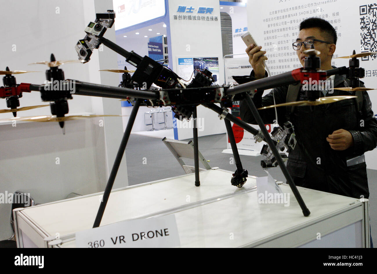 Shanghai. 7th Dec, 2016. A visitor takes photos of a 360 VR drone at the National Association of Broadcasters (NAB) Show Shanghai held in east China's Shanghai, Dec. 7, 2016. Building on the strength and success of the NAB Show brand and its global influence, Shanghai's show is the premier event for the broadcast and transmedia industry in the Asia and Pacific region. Credit:  Fang Zhe/Xinhua/Alamy Live News Stock Photo
