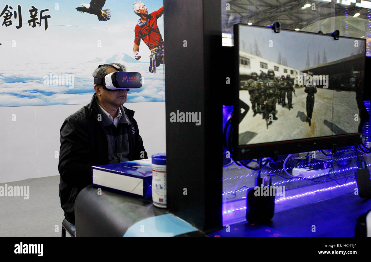 Shanghai. 7th Dec, 2016. A visitor tries VR glasses at the National Association of Broadcasters (NAB) Show Shanghai held in east China's Shanghai, Dec. 7, 2016. Building on the strength and success of the NAB Show brand and its global influence, Shanghai's show is the premier event for the broadcast and transmedia industry in the Asia and Pacific region. Credit:  Fang Zhe/Xinhua/Alamy Live News Stock Photo
