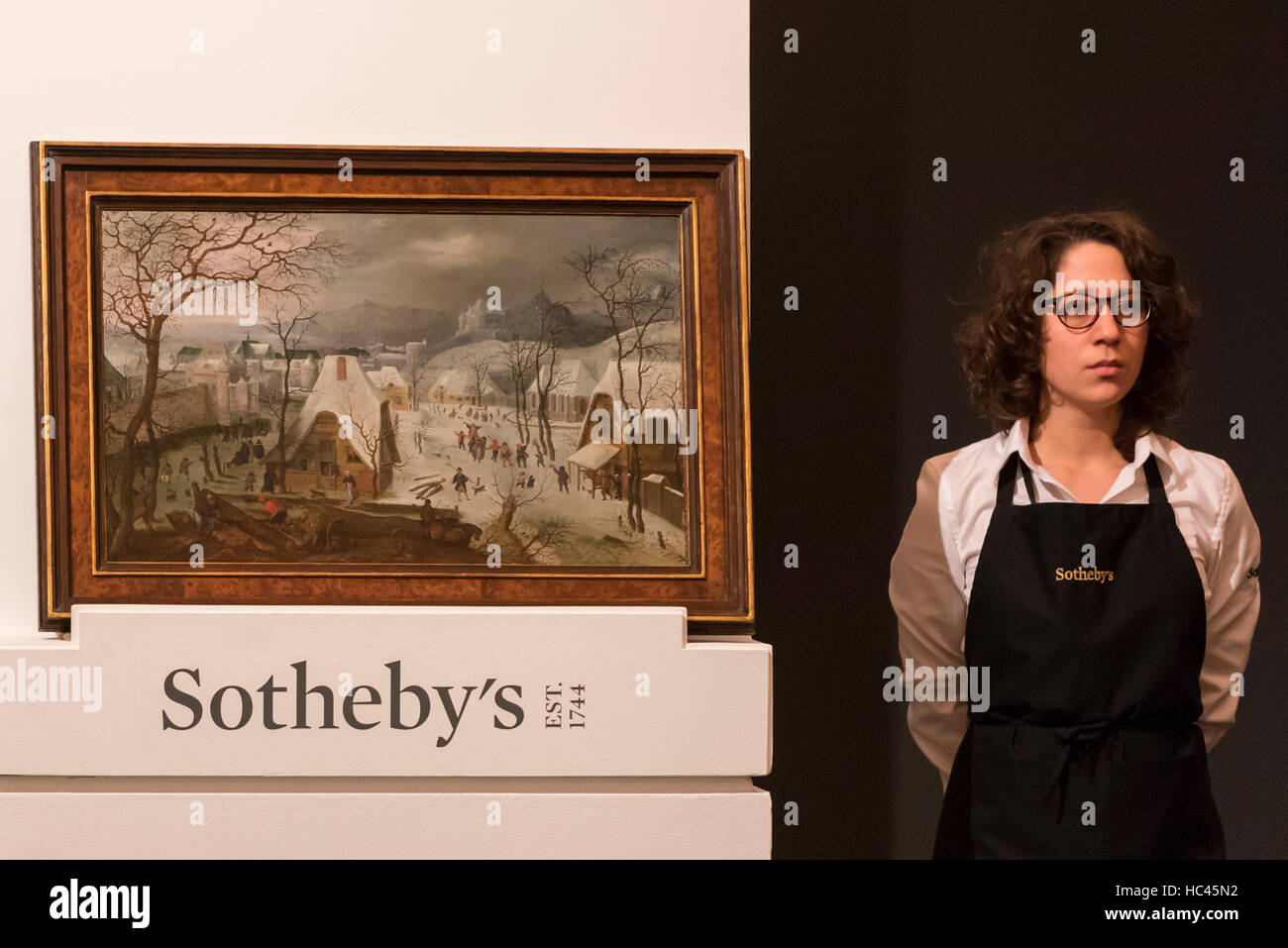 London, UK.  7 December 2016. 'The Season of Winter: A snowy landscape with a wedding procession and figures playing on the ice outside a walled town' by Jacob Savery the Elder which sold for a hammer price of GBP300k (est. GBP 200-300k) at the Old Masters Evening Sale at Sotheby's in New Bond Street Credit:  Stephen Chung / Alamy Live News Stock Photo