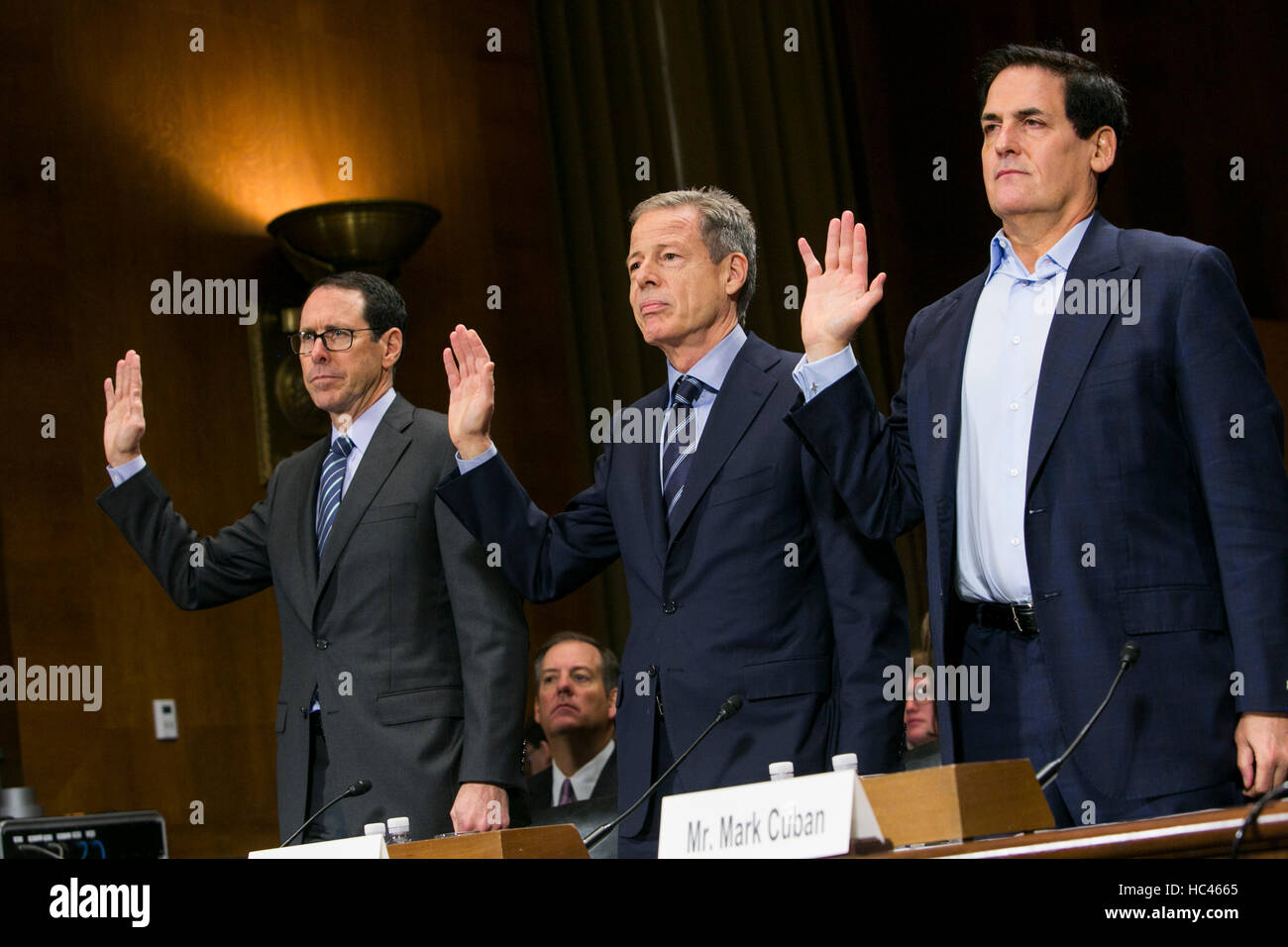 Washington DC, USA. 7th December, 2016. Randall Stephenson, Chairman & CEO of AT&T, left,  Jeffrey Bewkes, Chairman & CEO,Time Warner, center, and Mark Cuban, Chairman, AXS TV, right, are sworn in before the United States Senate Committee on the Judiciary Subcommittee on Antitrust, Competition Policy & Consumer Rights during a hearing on the pending AT&T and Time Warner merger in Washington, D.C. on December 7, 2016. Credit:  Kristoffer Tripplaar/Alamy Live News Stock Photo