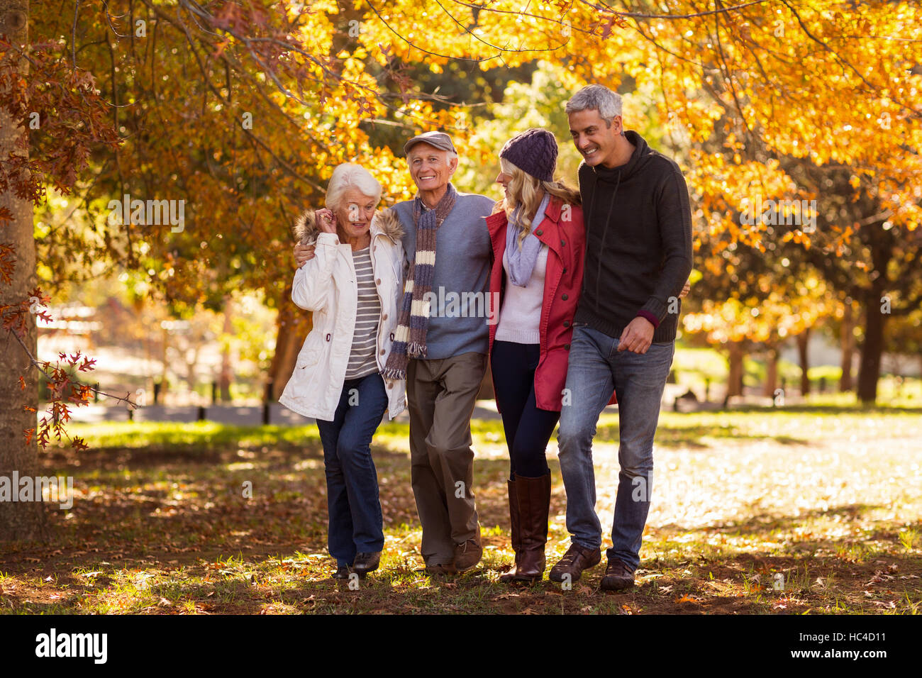 Happy family walking at park Stock Photo - Alamy