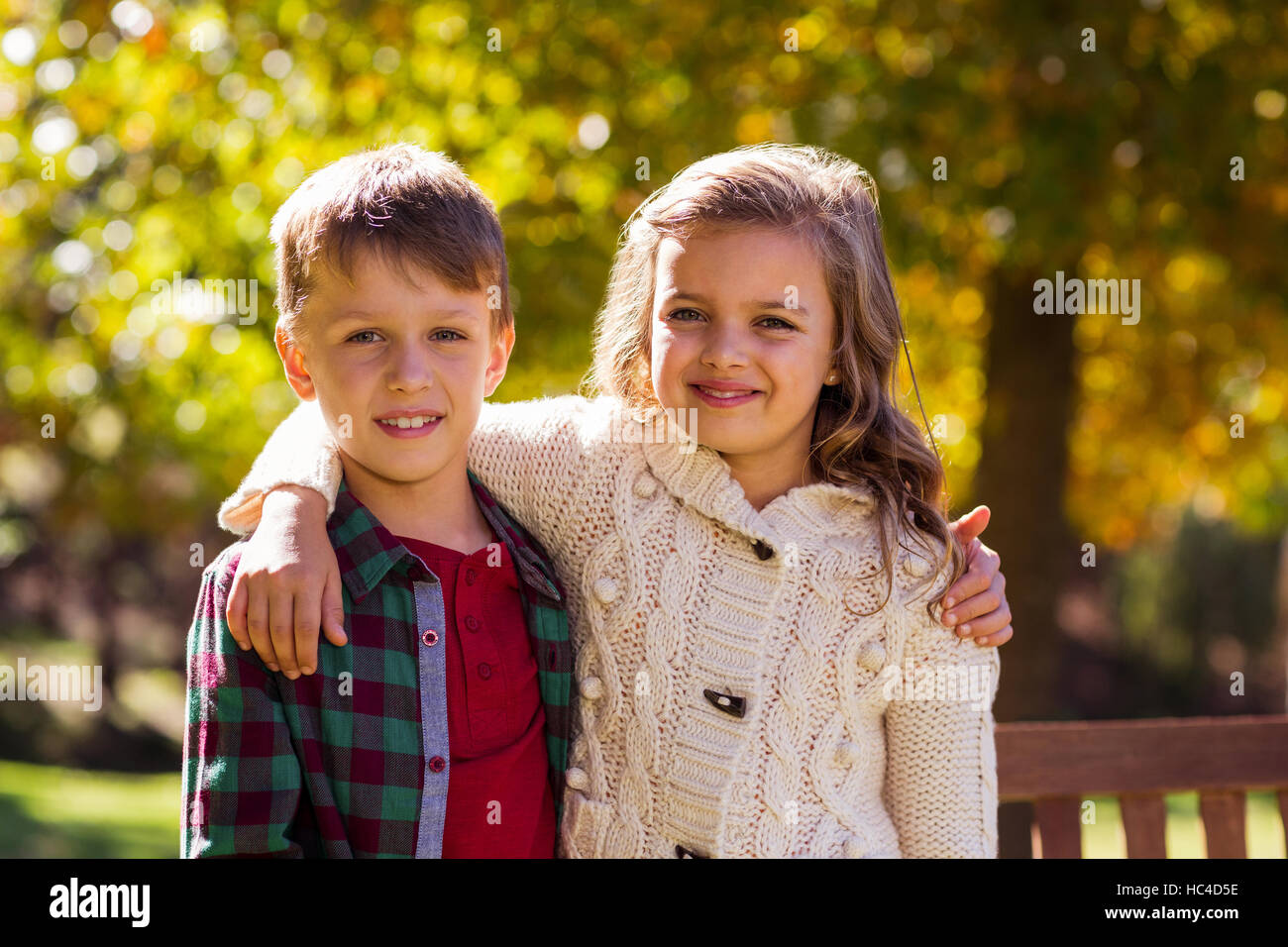 Portrait of smiling siblings at park Stock Photo - Alamy