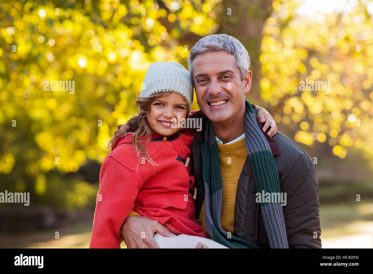 Father carrying daughter at park Stock Photo - Alamy