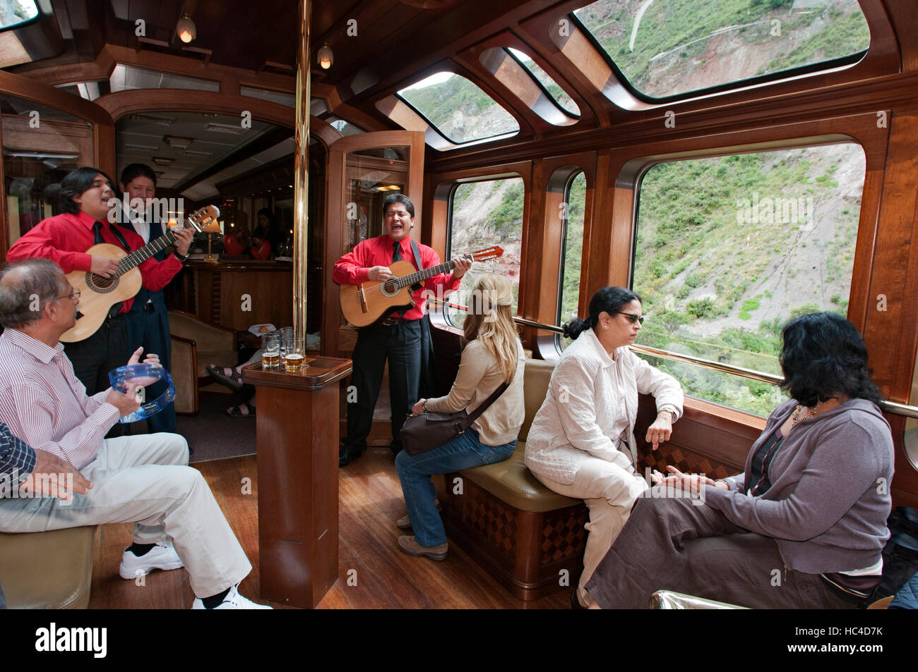 Peru Luxury train from Cuzco to Machu Picchu. Orient Express. Belmond.  Observation car entertained by musicians and dancers in traditional  costumes at Stock Photo - Alamy