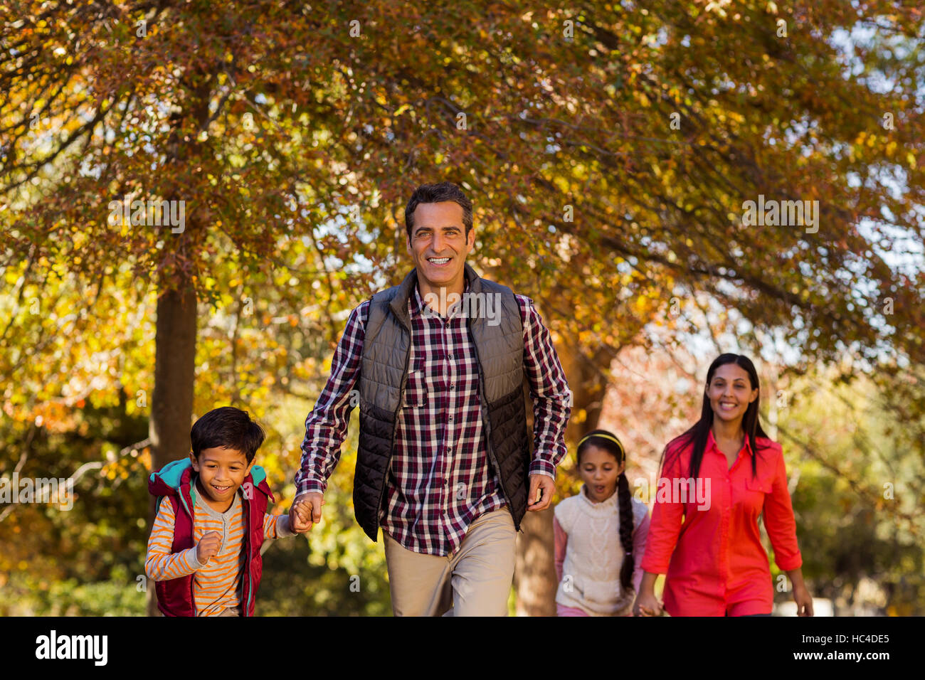 Family walking at park during autumn Stock Photo Alamy