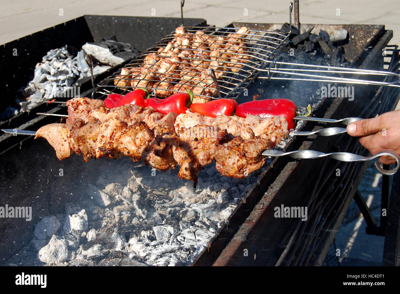 Preparation of barbecue meat shish kebab on skewers grill food. Man