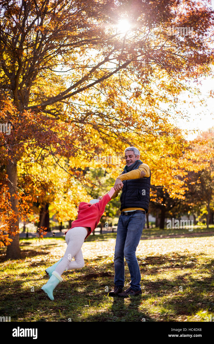 Father playing with daughter at park Stock Photo - Alamy