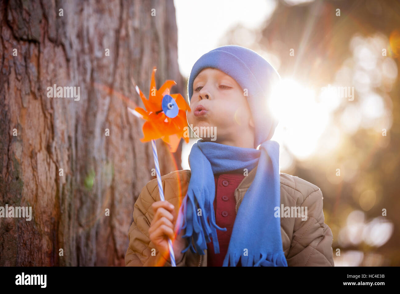 Cute boy blowing pinwheel Stock Photo Alamy