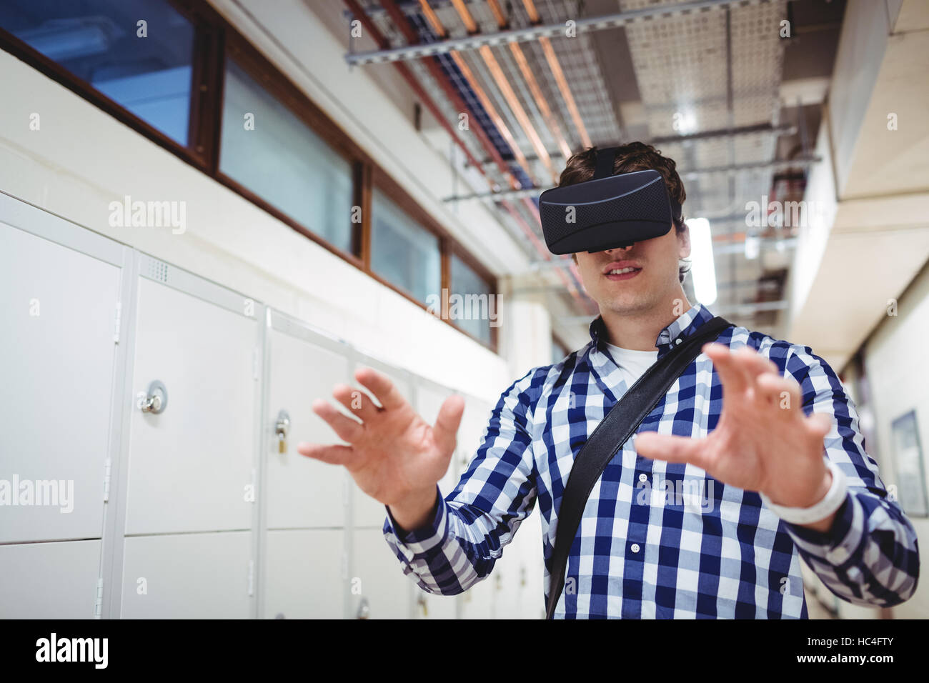 Student using virtual reality headset in locker room Stock Photo Alamy