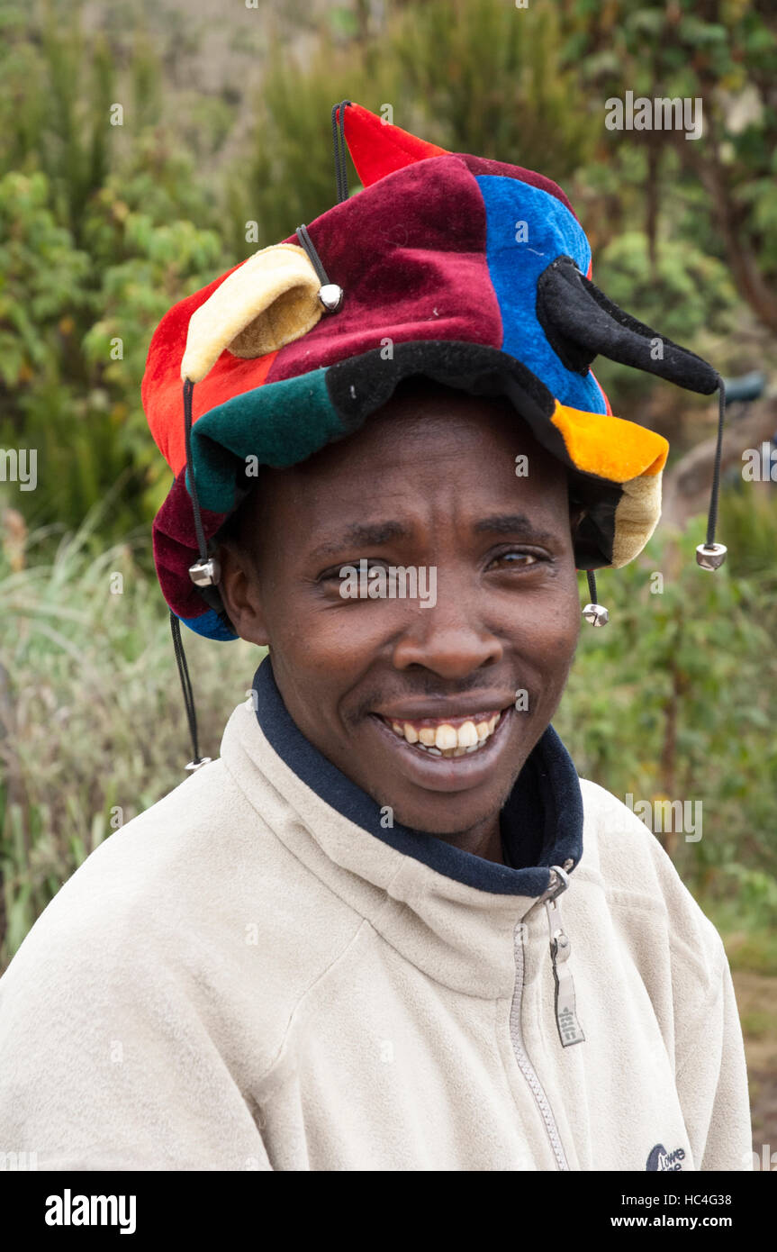 Porter with multi-colored jester hat, Machame Route, Kilimanjaro, Tanzania Stock Photo