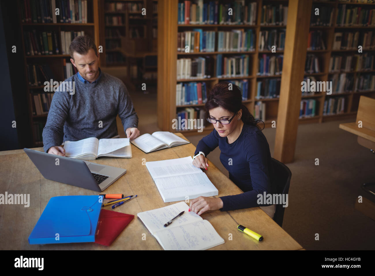 Mature students working together in college library Stock Photo