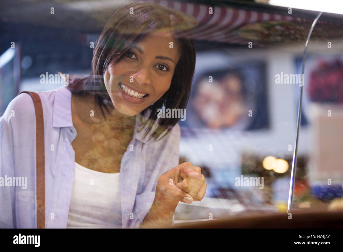 Excited woman pointing at display Stock Photo