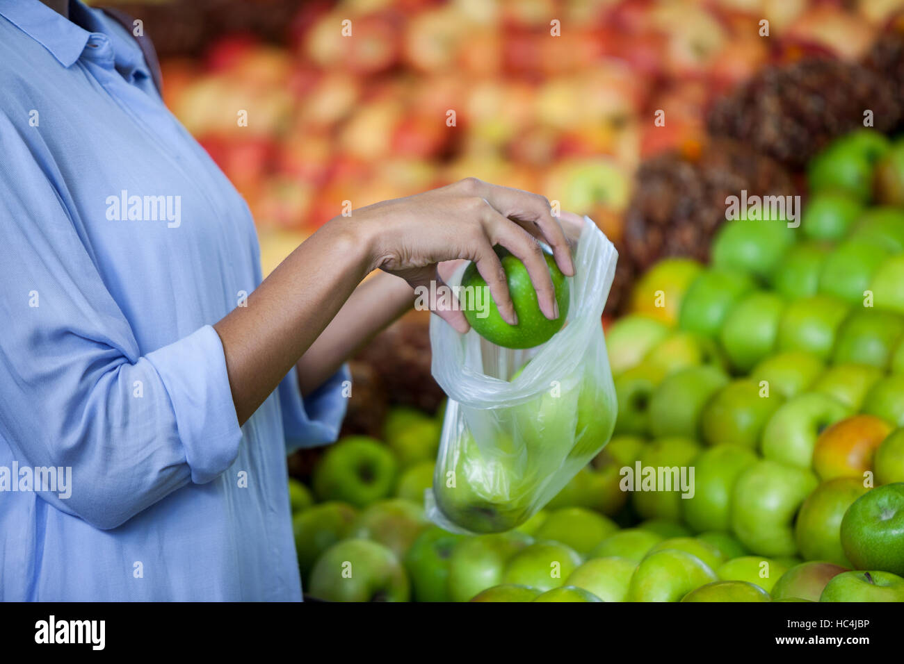 Woman buying an apple Stock Photo