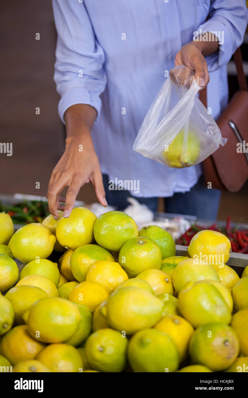 Woman buying sweet lime Stock Photo