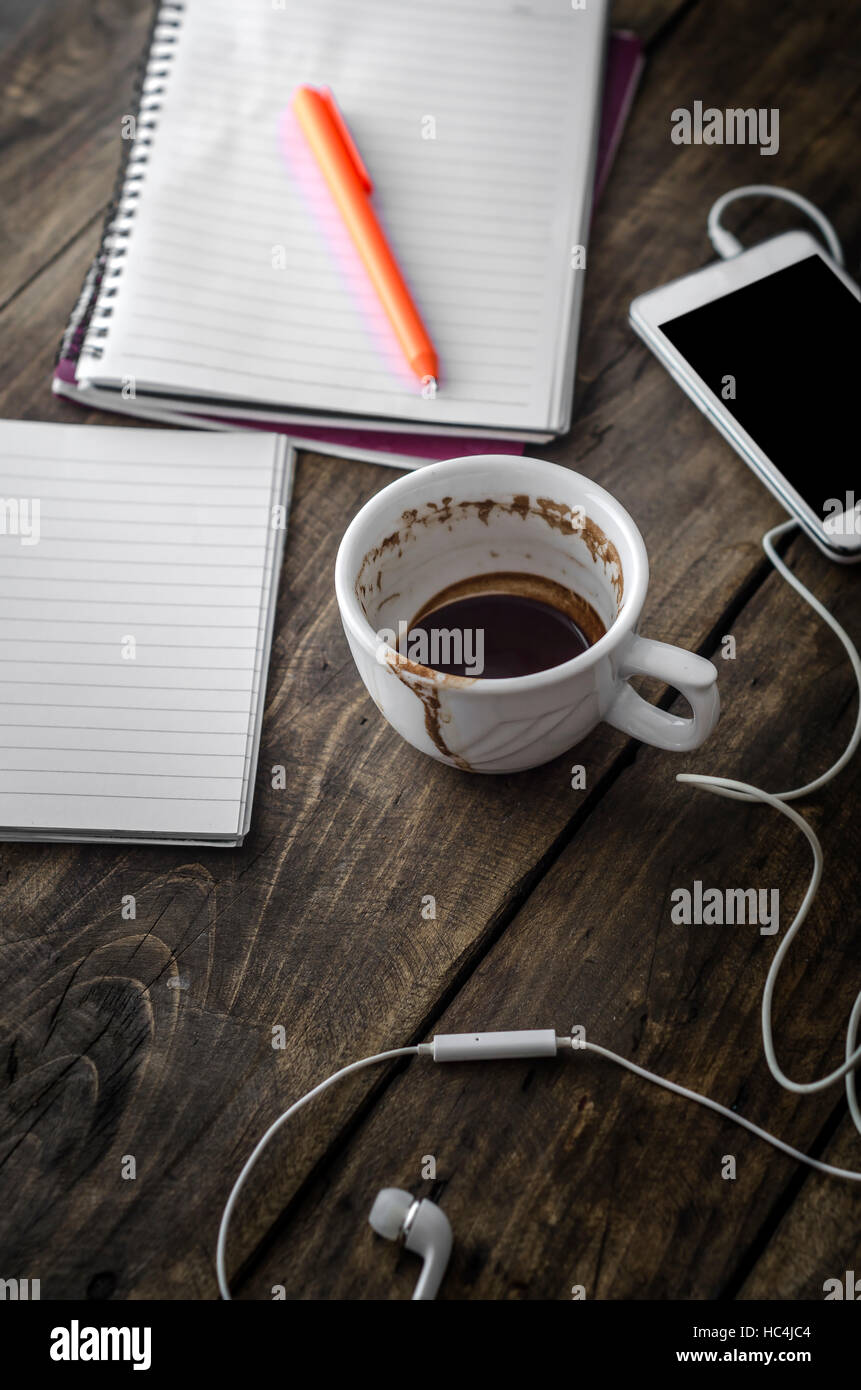 Busy working desk with stained coffee cup Stock Photo