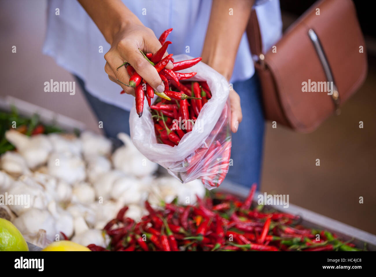 Woman buying red chilies Stock Photo