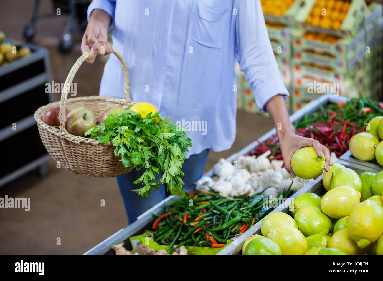 Woman buying sweet lime in organic section Stock Photo