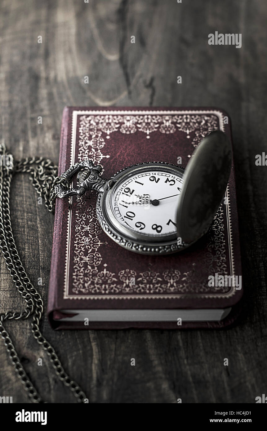 pocket watch with red notebook in close up Stock Photo