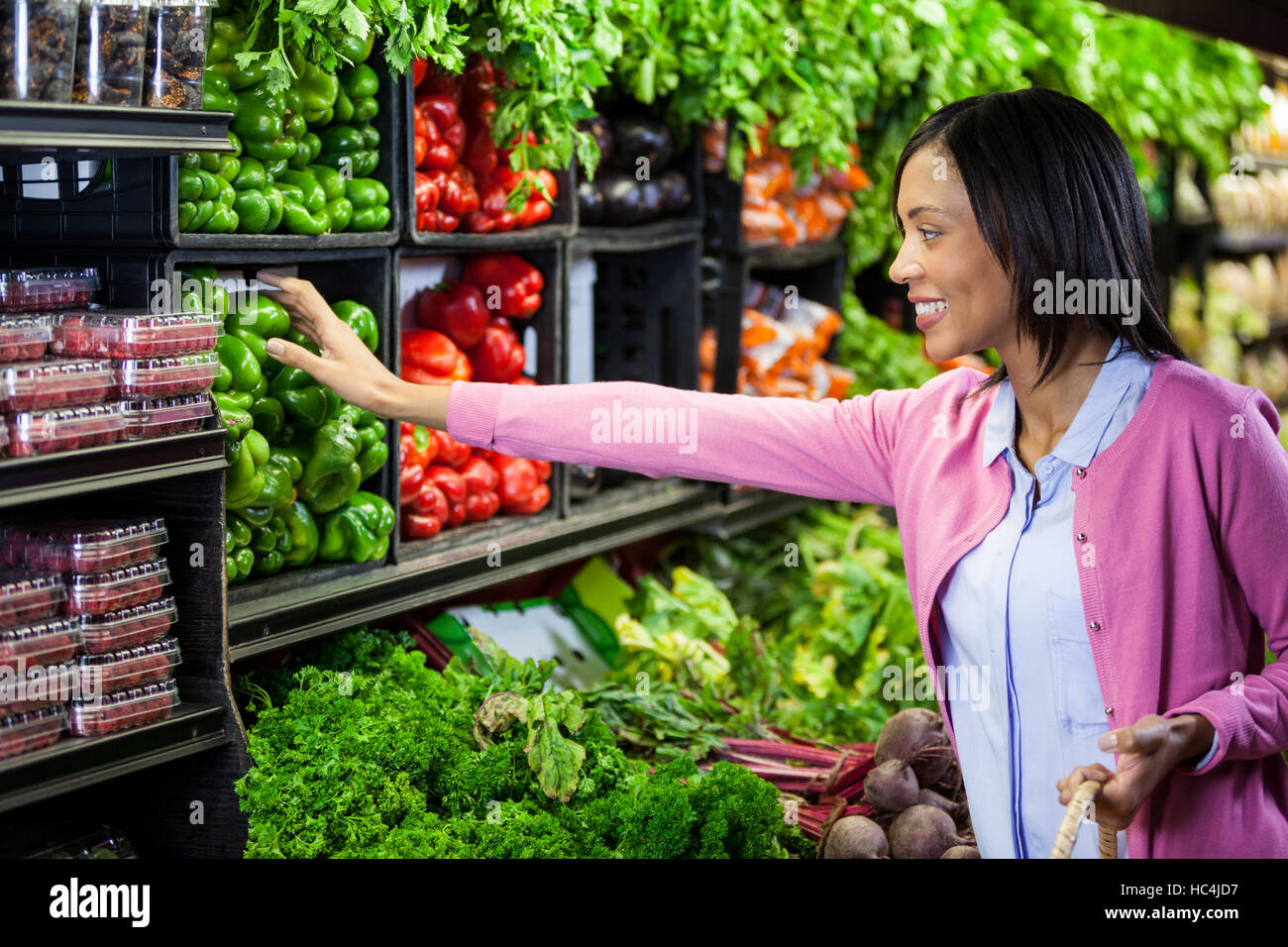 Woman buying vegetables in organic section Stock Photo