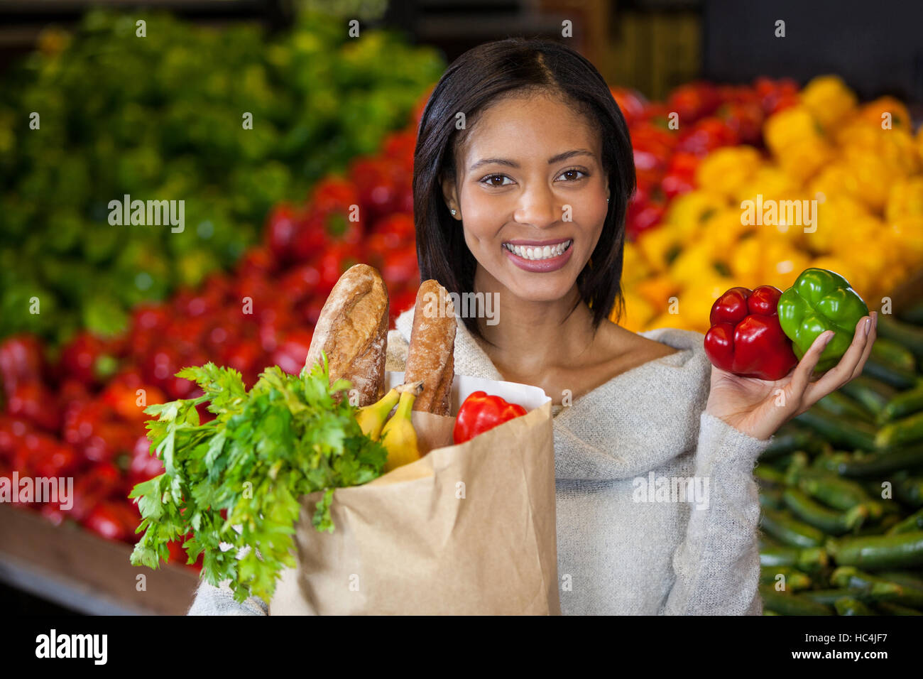 Woman holding vegetables in organic section Stock Photo