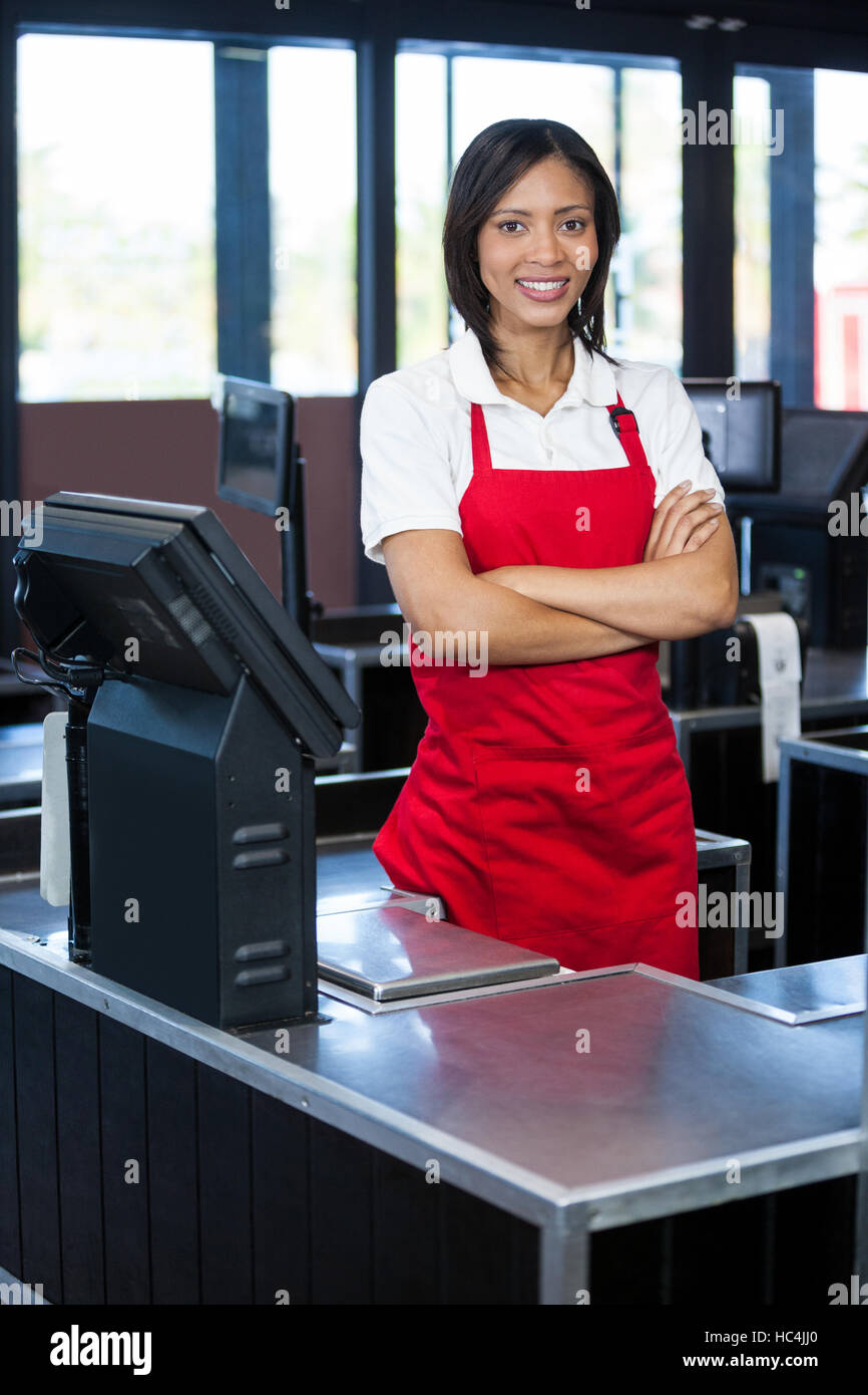 Female staff standing at cash counter Stock Photo