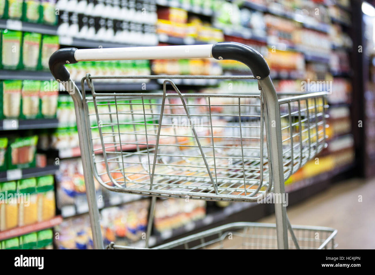 Empty shopping cart in grocery section Stock Photo