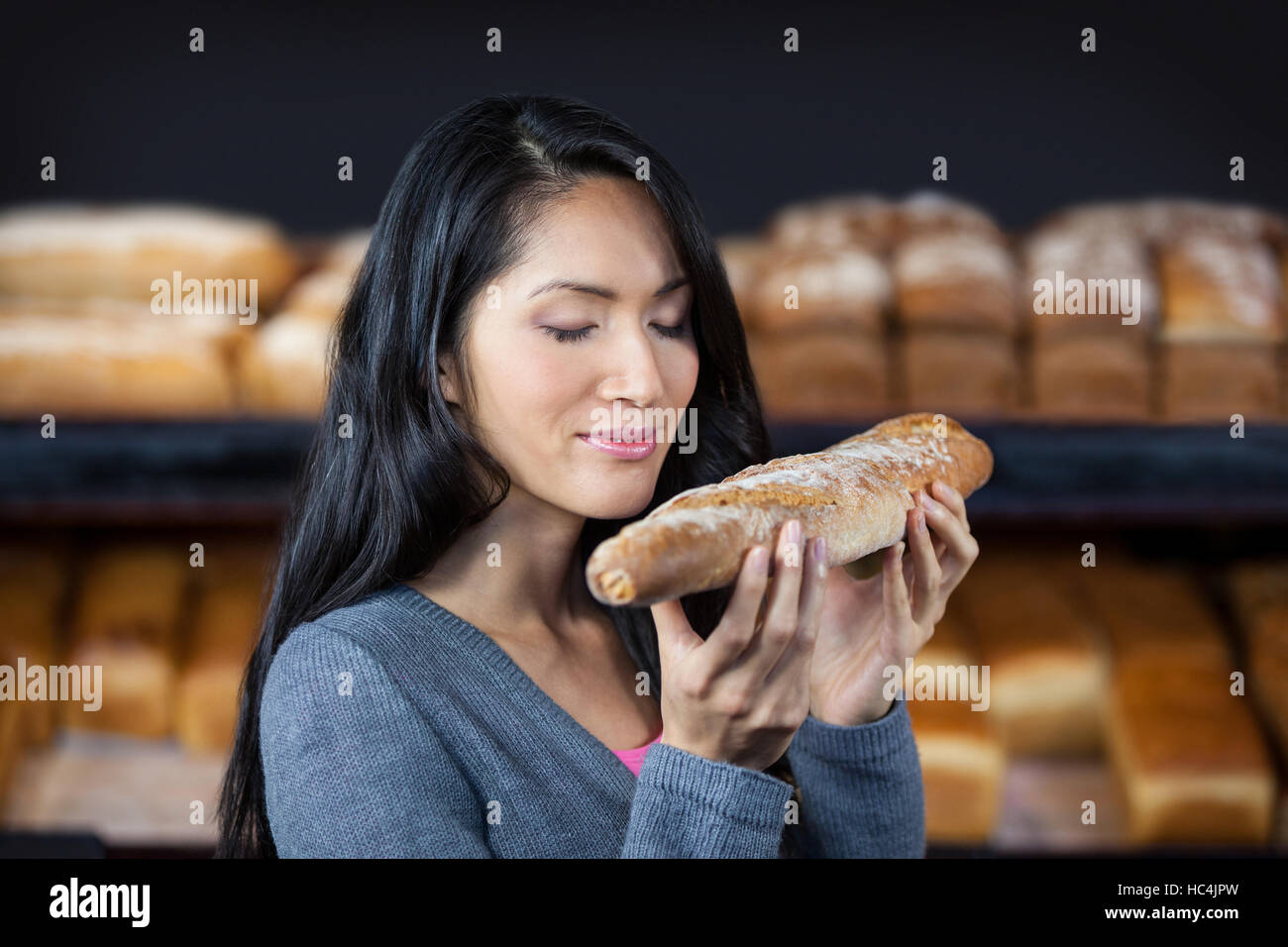 Woman smelling a baguette Stock Photo Alamy