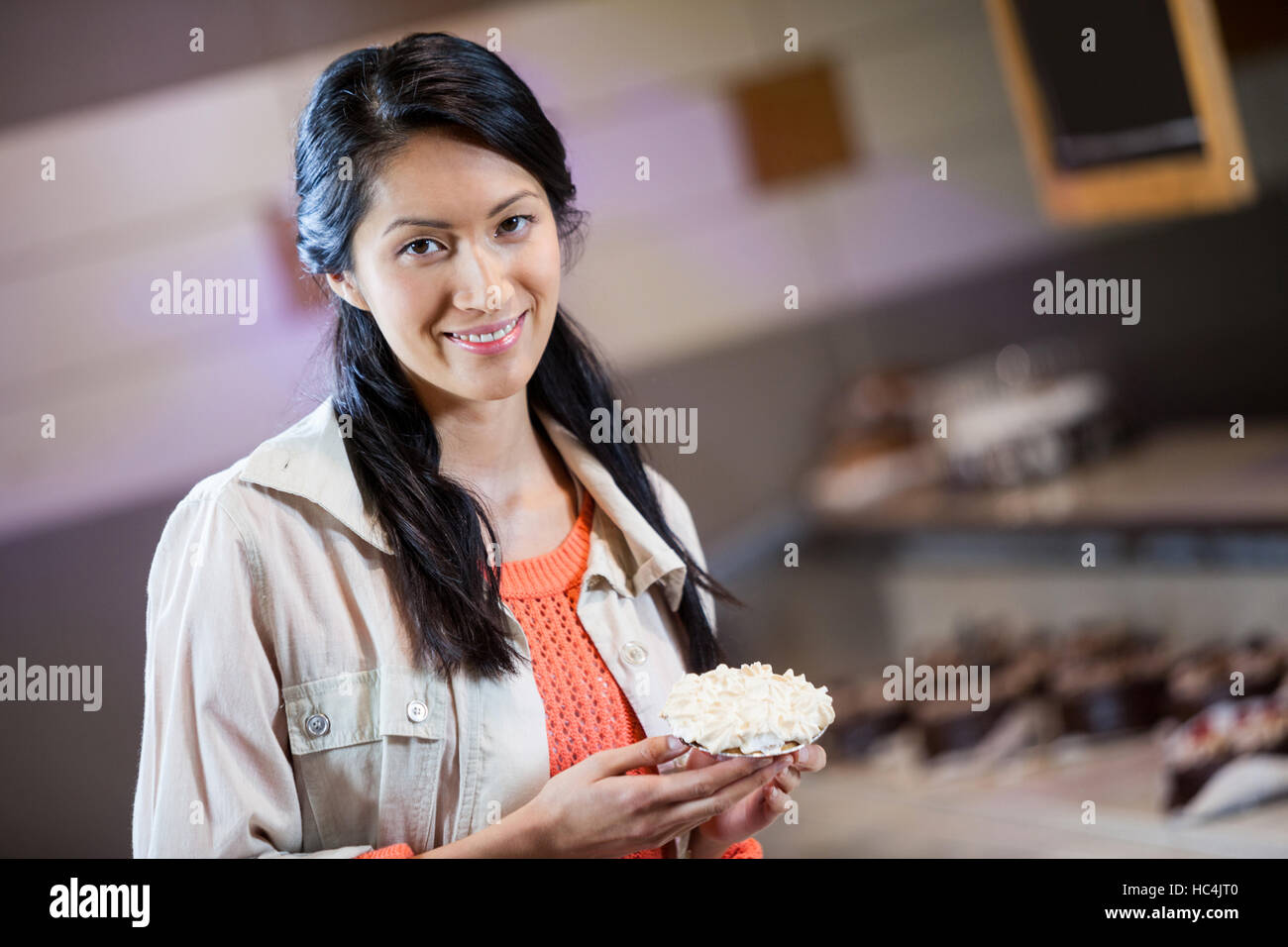 Portrait of woman holding sweet food Stock Photo