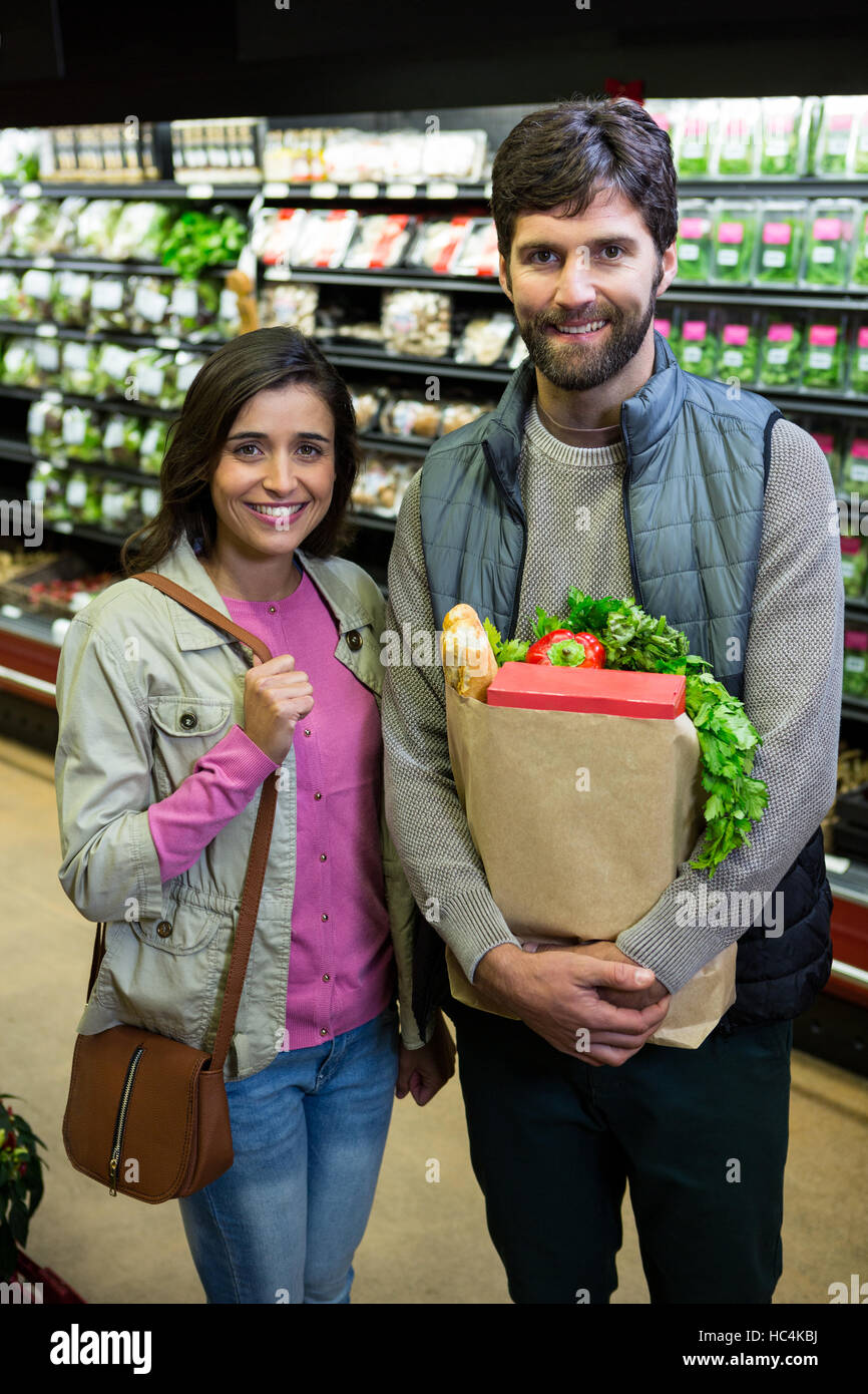 Couple shopping for vegetables in organic section of supermarket Stock Photo
