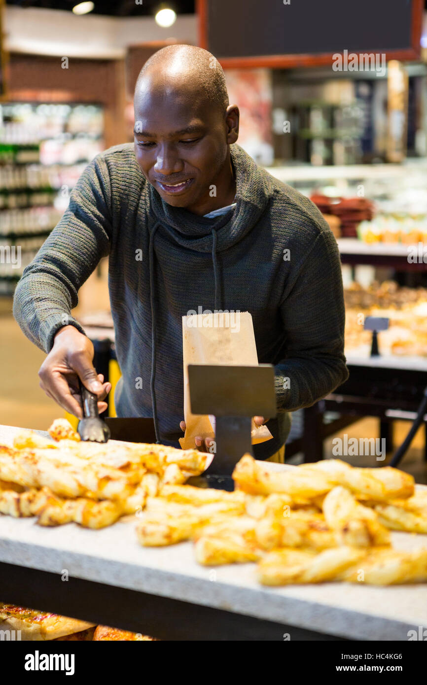 Smiling man purchasing bread Stock Photo