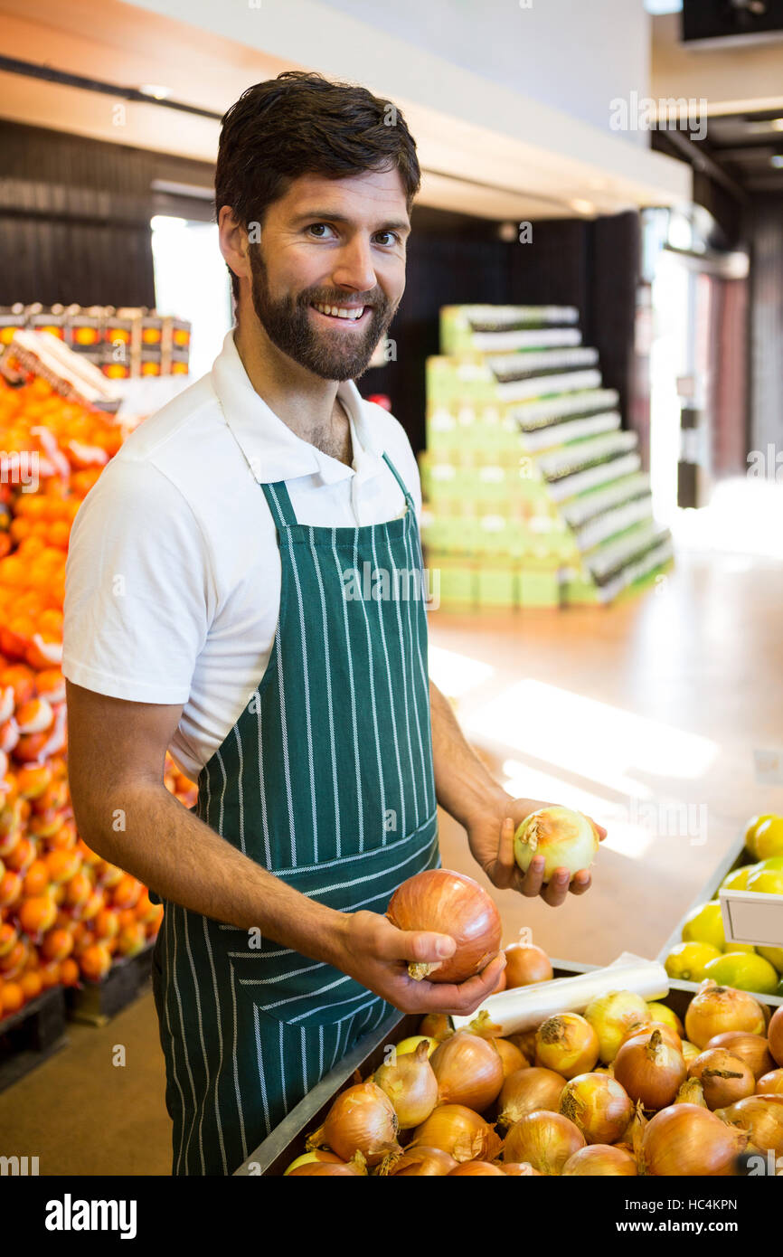 Male staff arranging fruits in organic section of supermarket Stock Photo