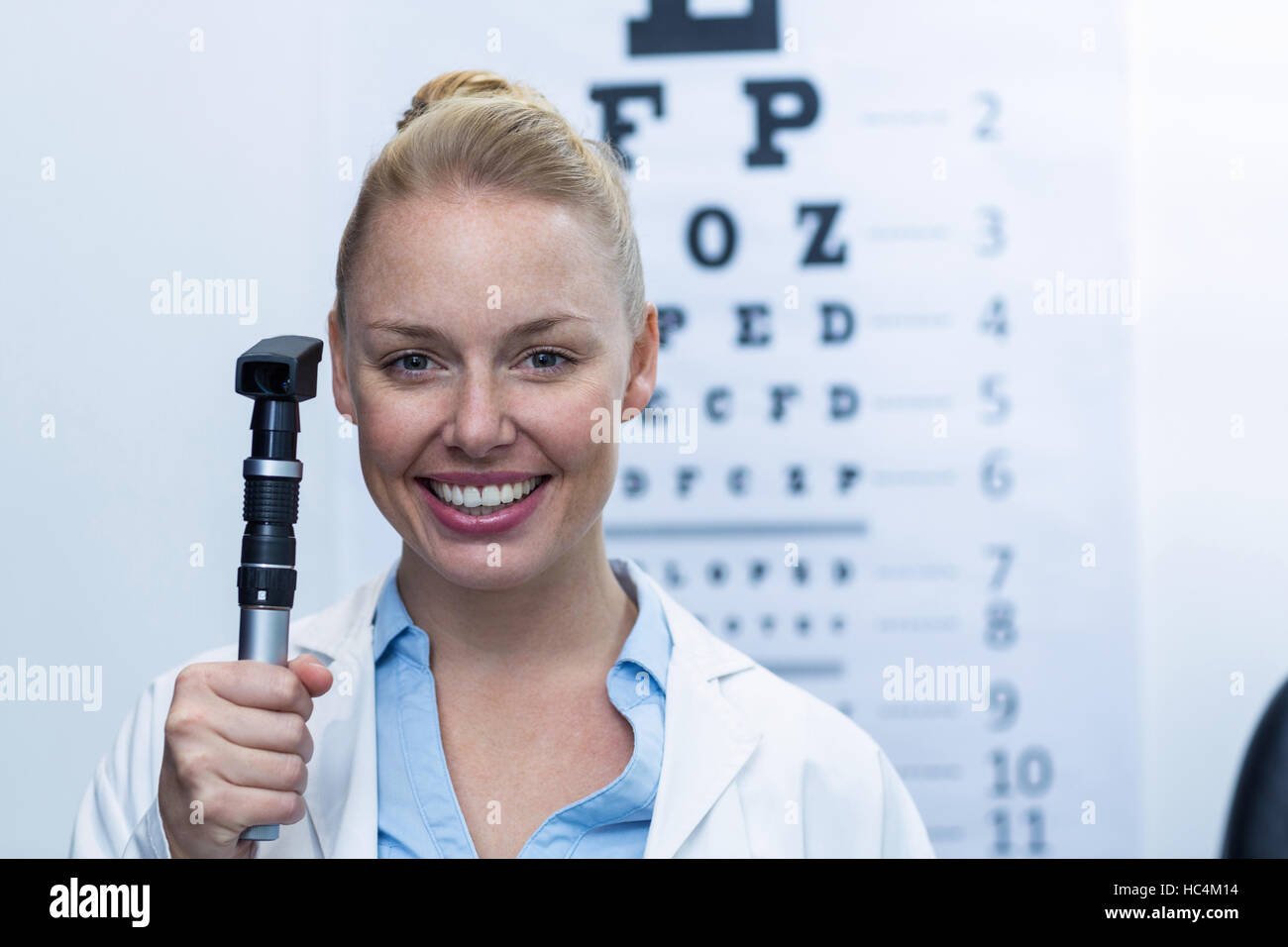 Female optometrist holding ophthalmoscope Stock Photo Alamy
