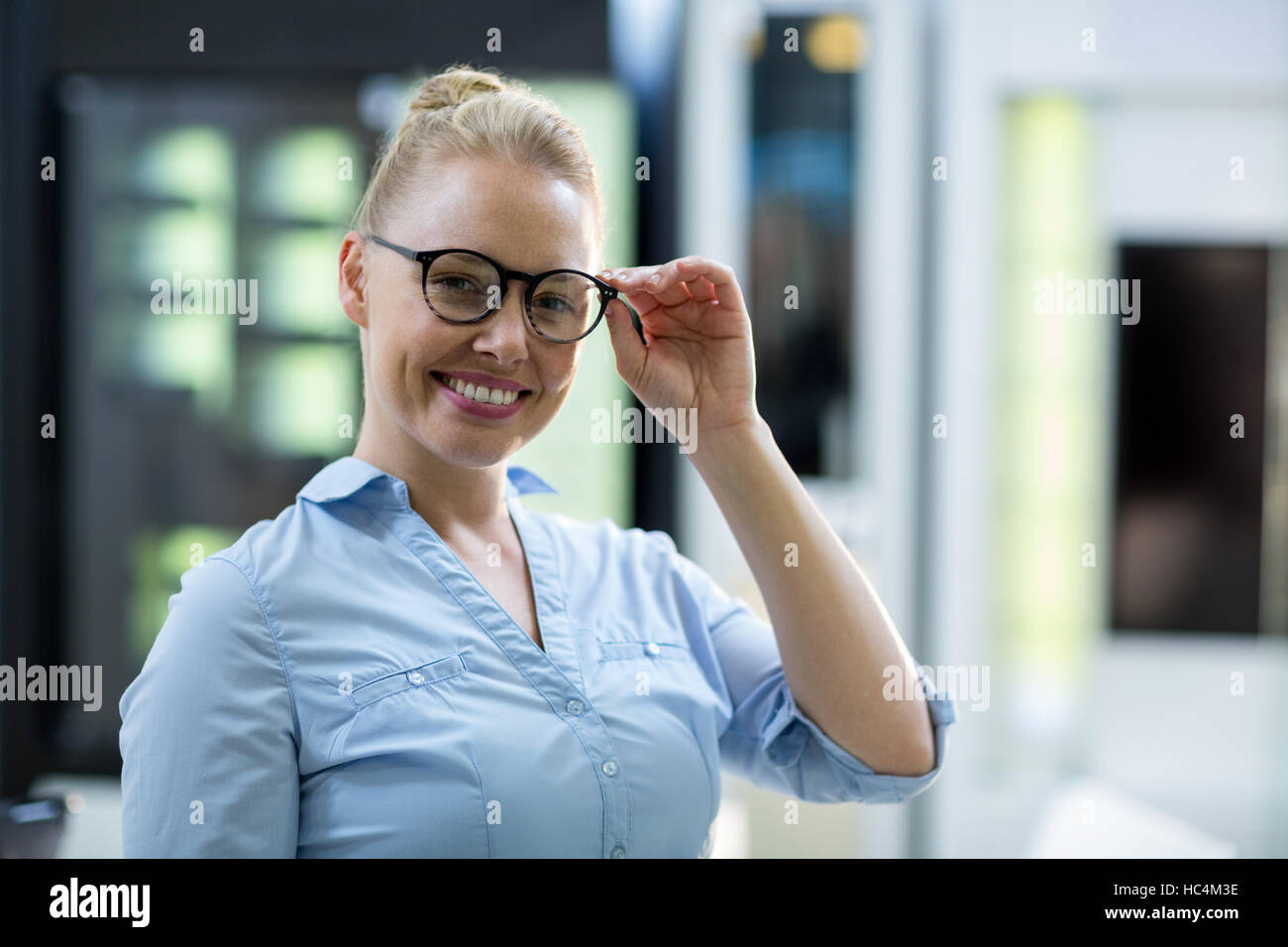 Smiling female customer trying spectacle Stock Photo