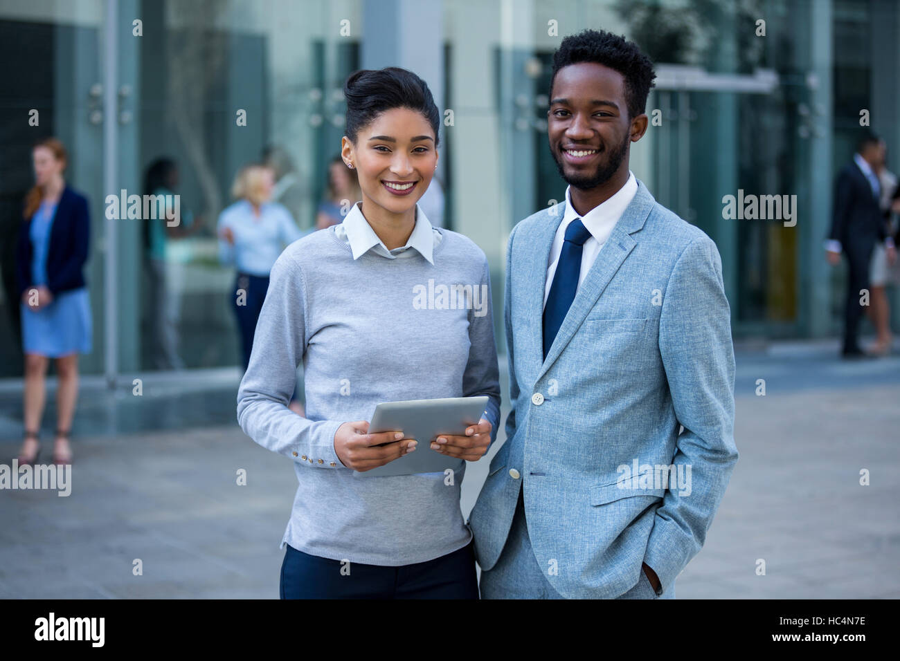 Portrait of businessman and colleague holding digital tablet Stock Photo