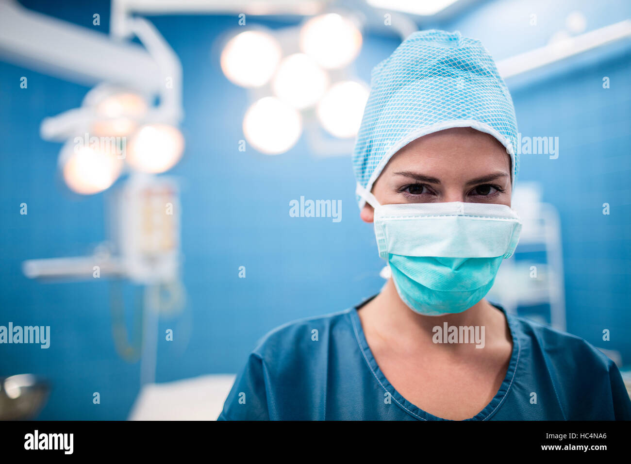 Portrait of surgeon standing in operation room Stock Photo - Alamy