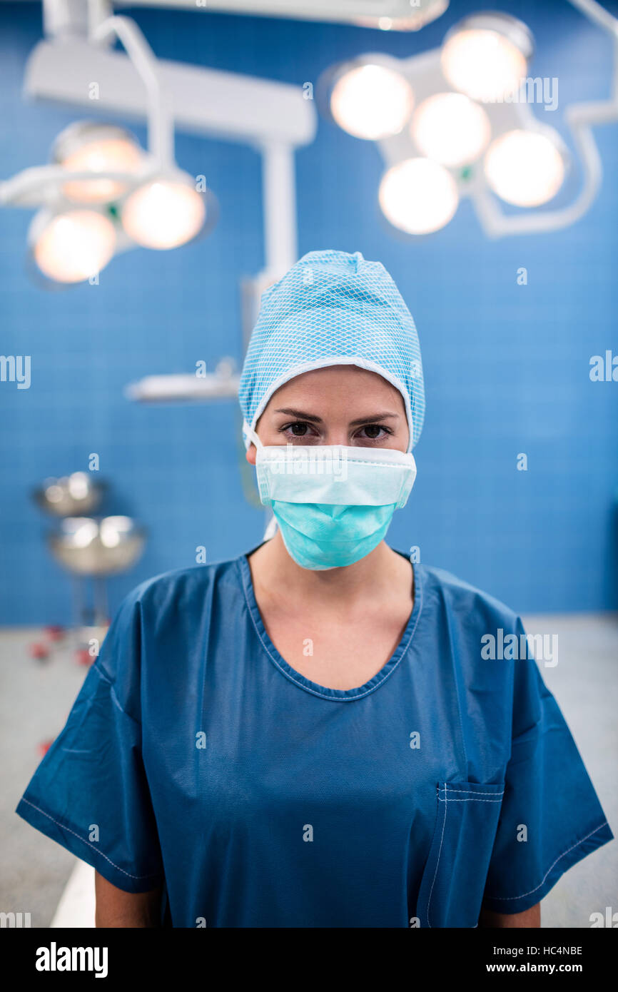 Portrait of surgeon standing in operation room Stock Photo