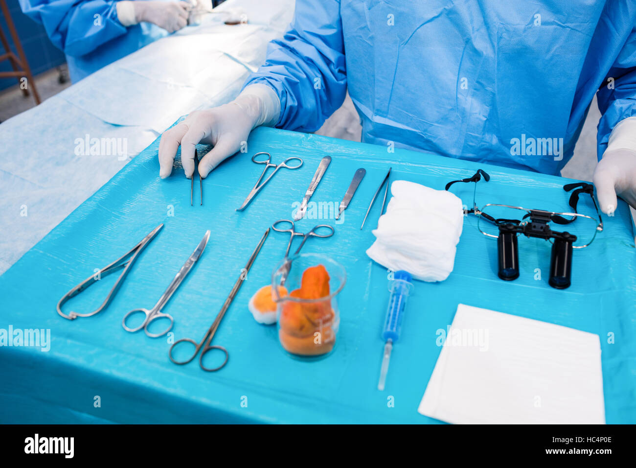 Surgeon with surgical tool on tray in operation room Stock Photo Alamy
