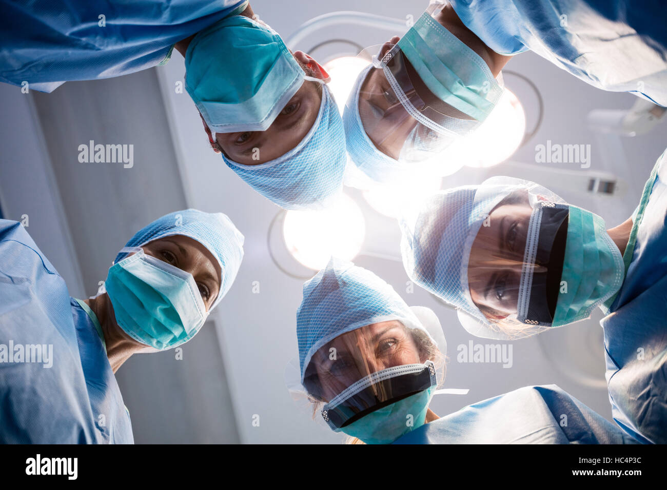 Group of surgeons looking at camera in operation room Stock Photo - Alamy