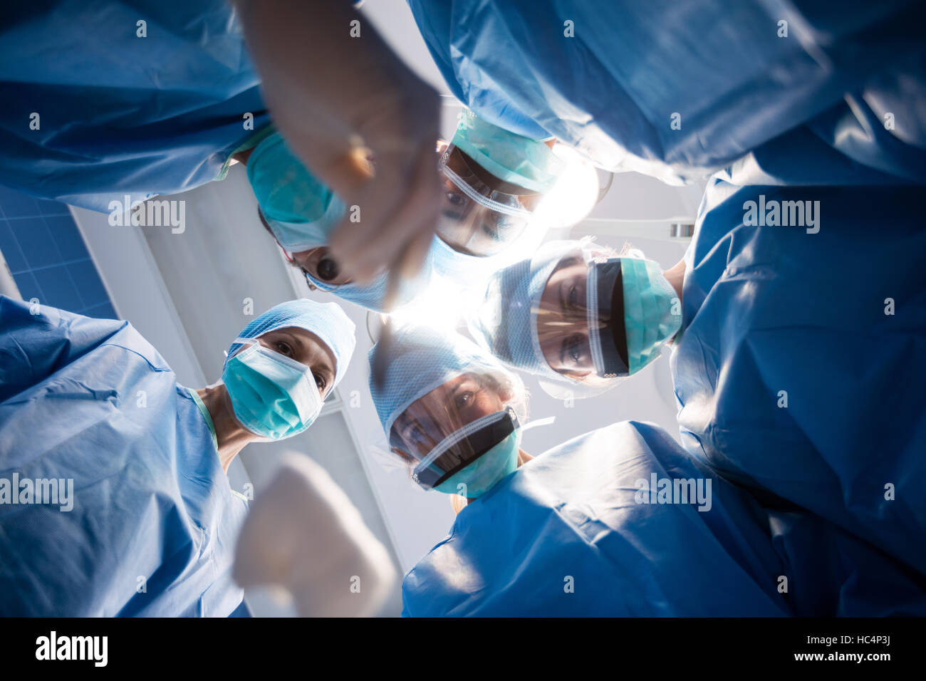Group of surgeons looking at camera in operation room Stock Photo