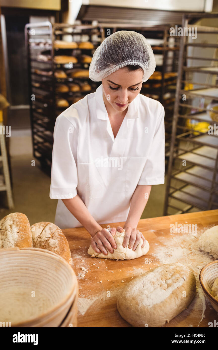 Female baker kneading a dough Stock Photo Alamy
