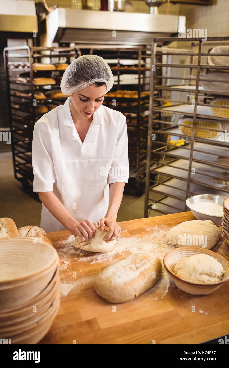 Female baker kneading a dough Stock Photo Alamy